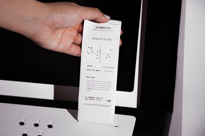 A photograph of a person's hand pulling a paper receipt out of a till in tones of white and black.