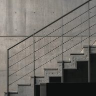 Geometric concrete staircase with simple steel railings