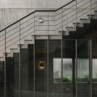 Concrete staircase with steel railings and glass panelling