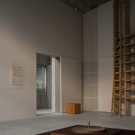 Gallery space with wooden exhibition pieces