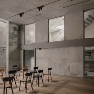 Chairs lined up in concrete hall with wooden floor