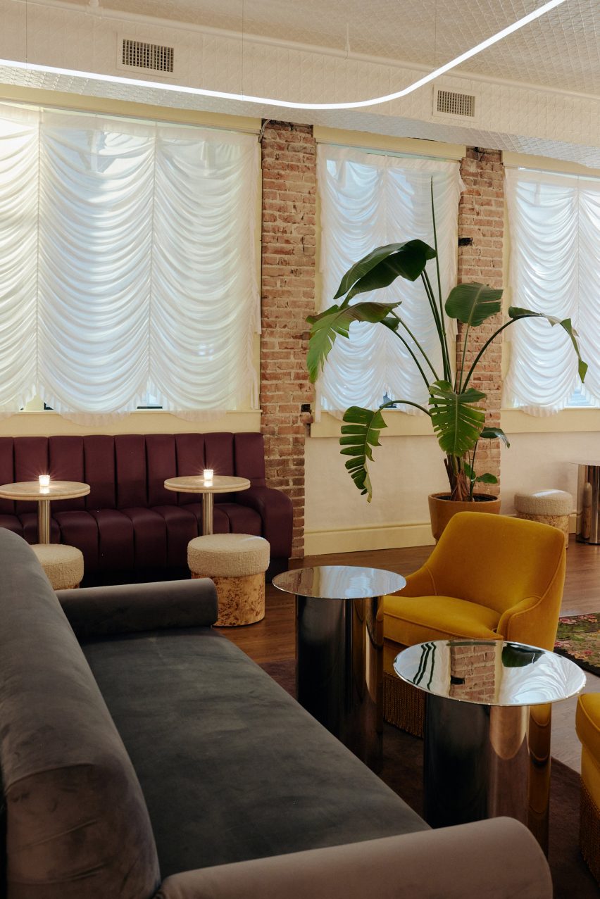 Lounge area with assortment of chairs and white drapes