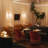 Dimly lit bar lounge area with illuminated wall sconces
