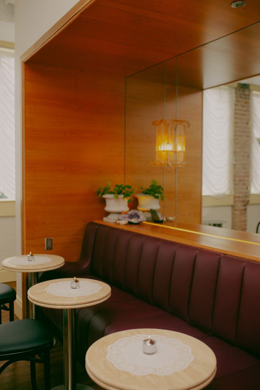 Purple leather bench surrounded by wood panelling