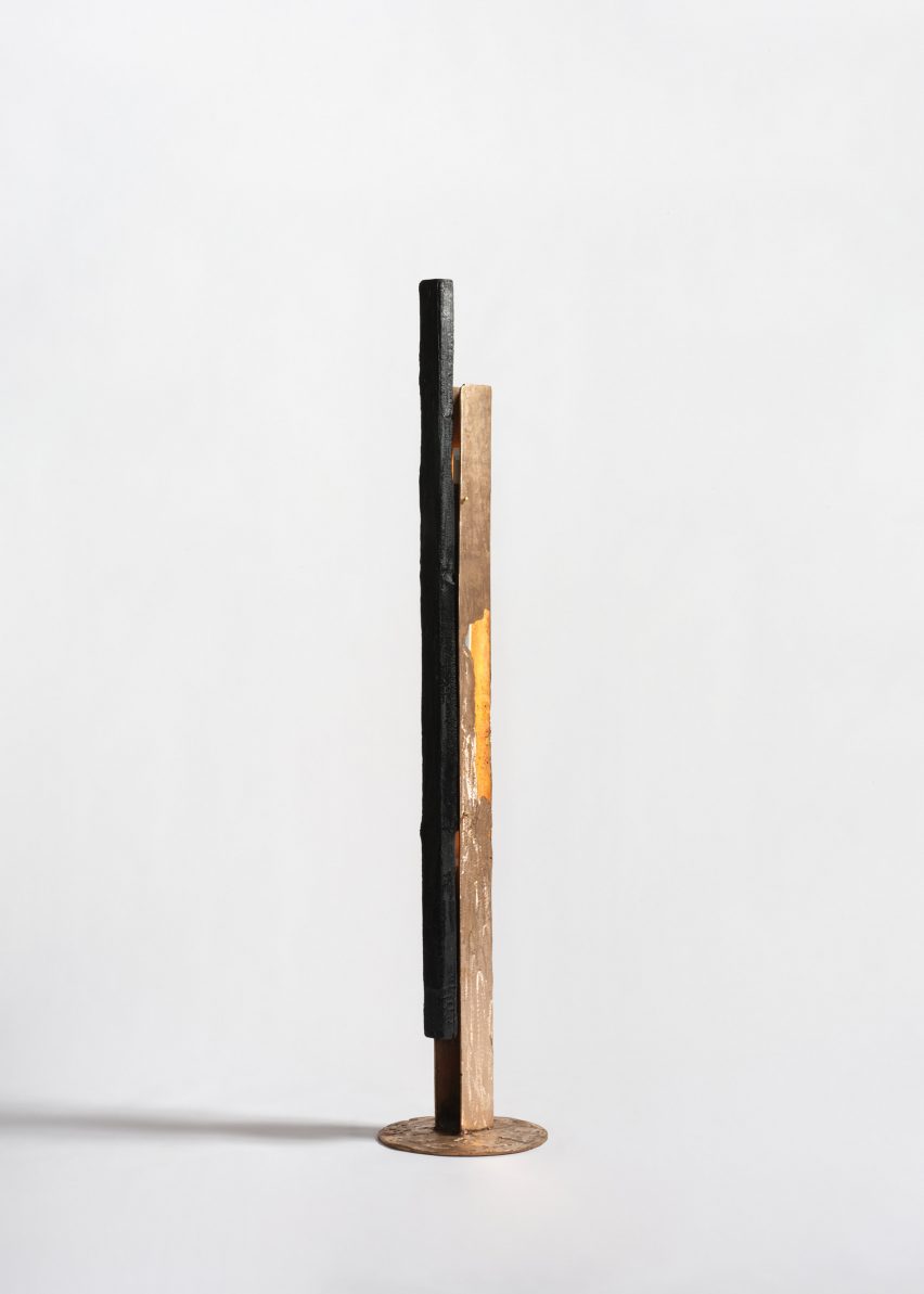 Studio photo of a tall lamp made from a long, rectangular piece of copper
