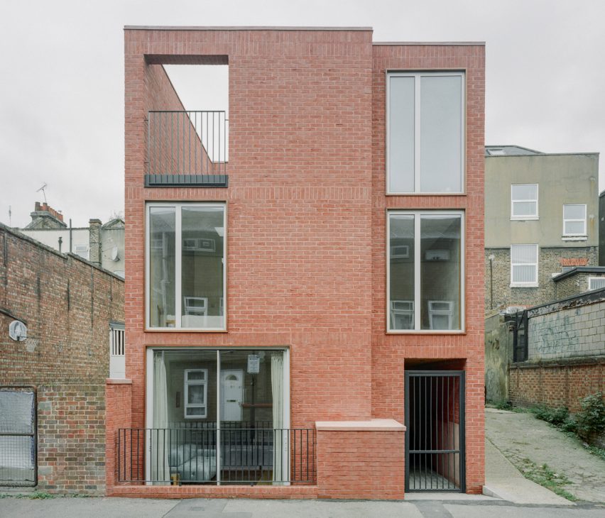 Exterior view of redbrick townhouse by Nikjoo