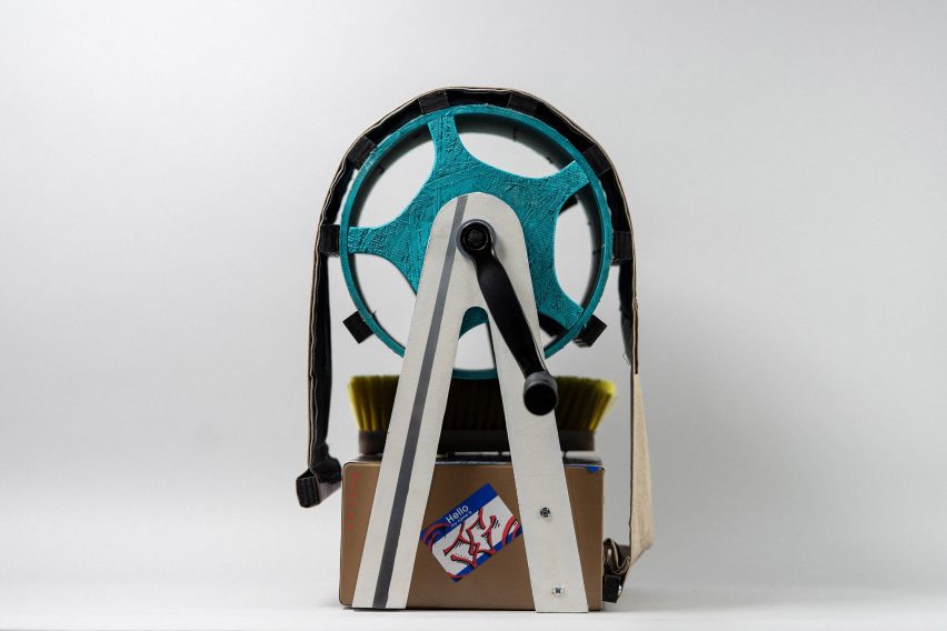 Photo of a contraption with a hand-cranked teal drum at its centre made to create a sound effect by students Jude Gill, Chipper Orban and Grace Kim