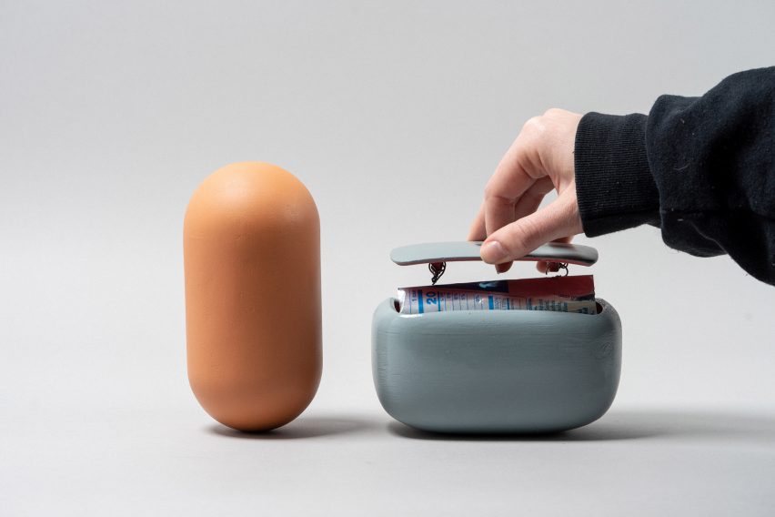 Photo of two smooth capsules, one with a lid being lifted up to reveal a element, created to make Foley sounds by students Erin Shaw, Aliina Lange and Sophia Foster