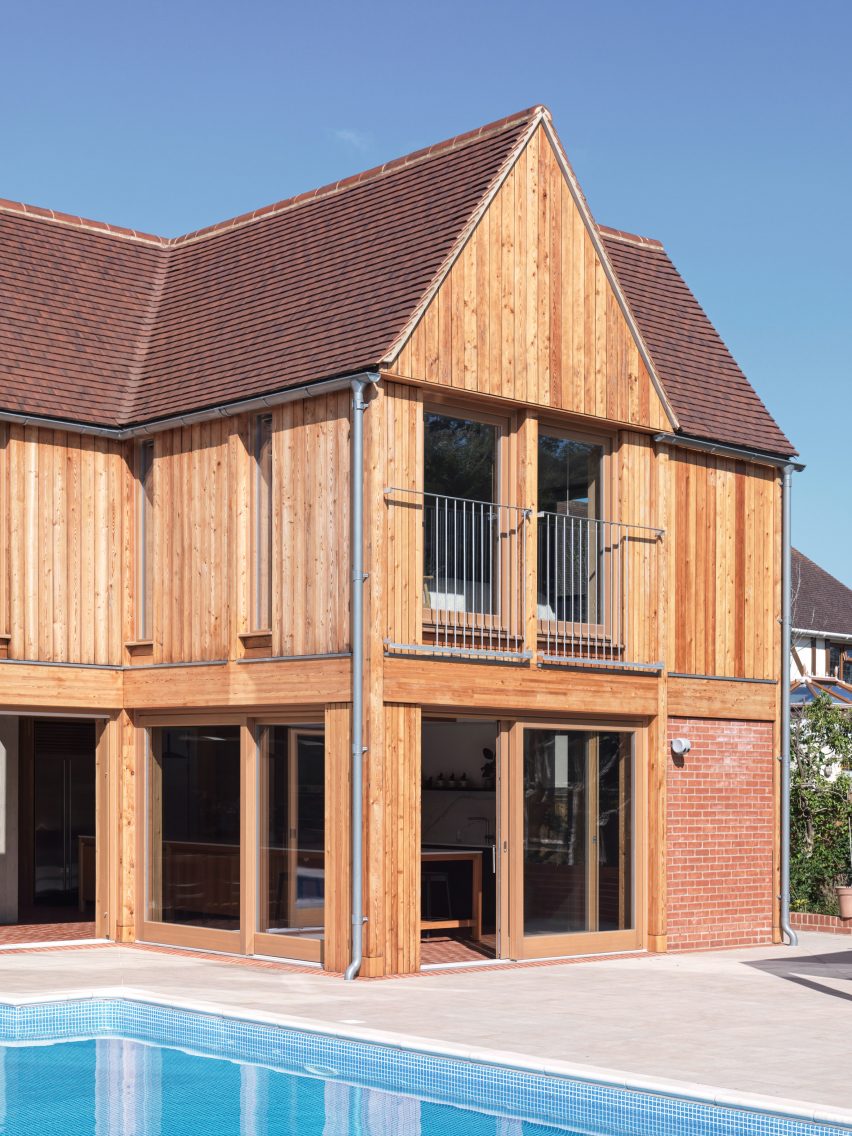 Exterior view of Tudor-style home by Threefold Architects