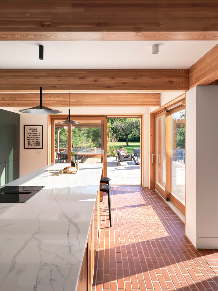 Kitchen interior within Tudor-style house by Threefold Architects