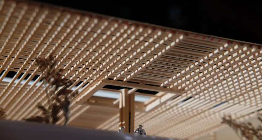 A cropped photograph of an architectural model, displaying a perforated surface in tones of brown.