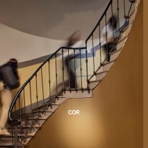 Photo of staircase with Cor logo