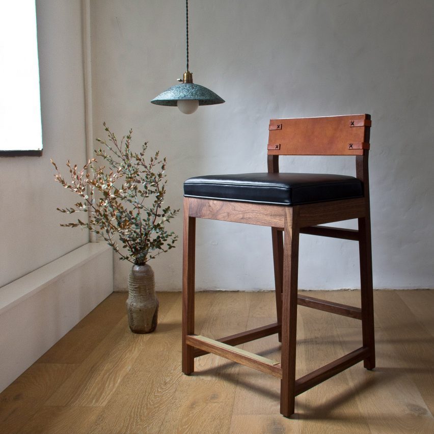 Wooden stool next to lamp and plant