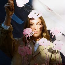 Photo of Faye Toogood holding up sheet with pink floral design