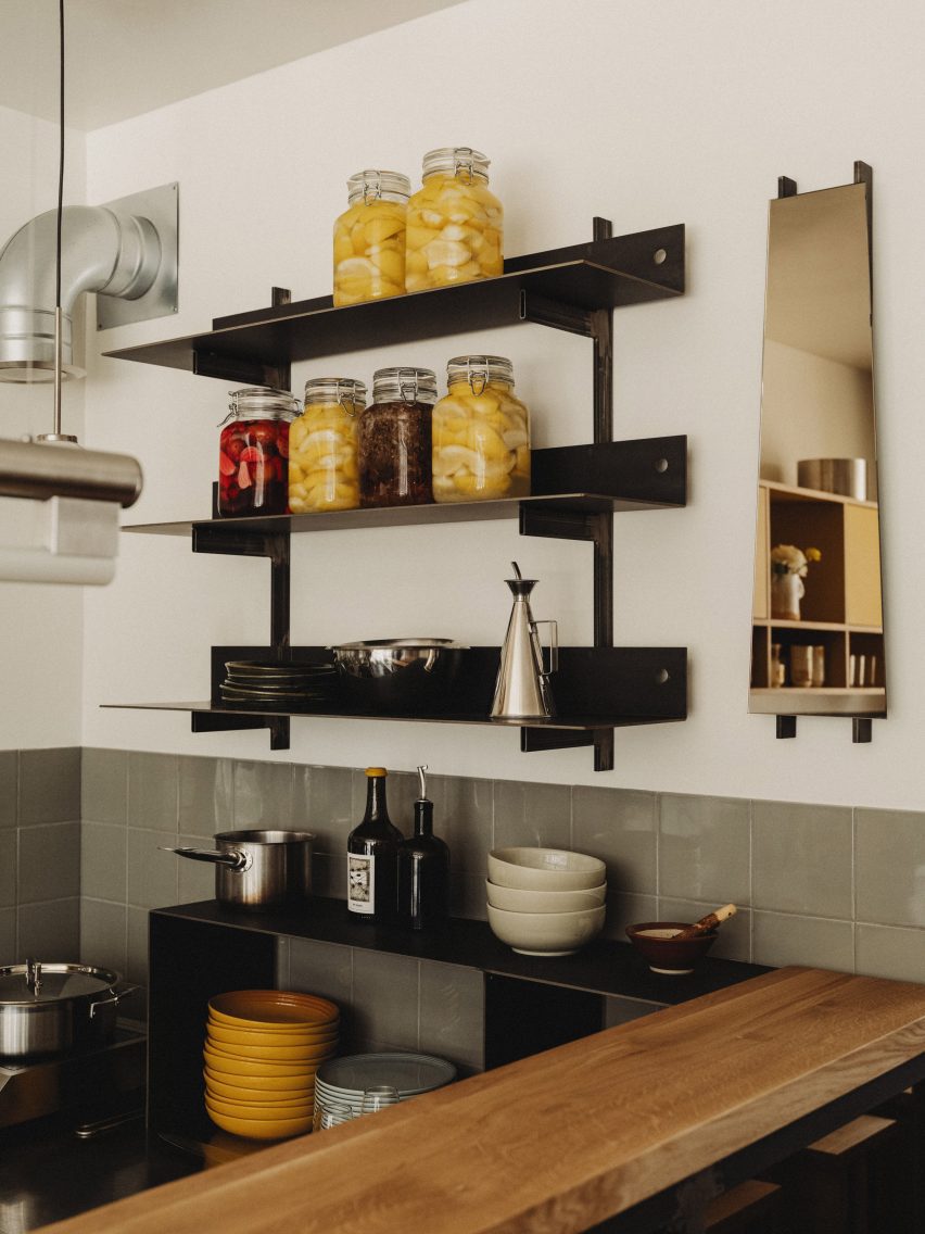 Close-up photograph of the minimalist kitchen shelving units that have been handcrafted from steel. 