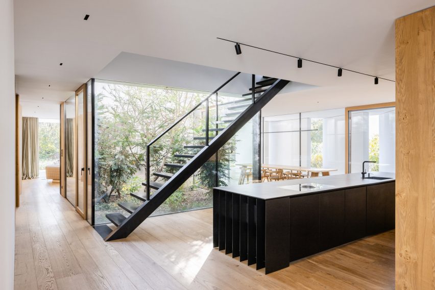 Black staircase in modern kitchen