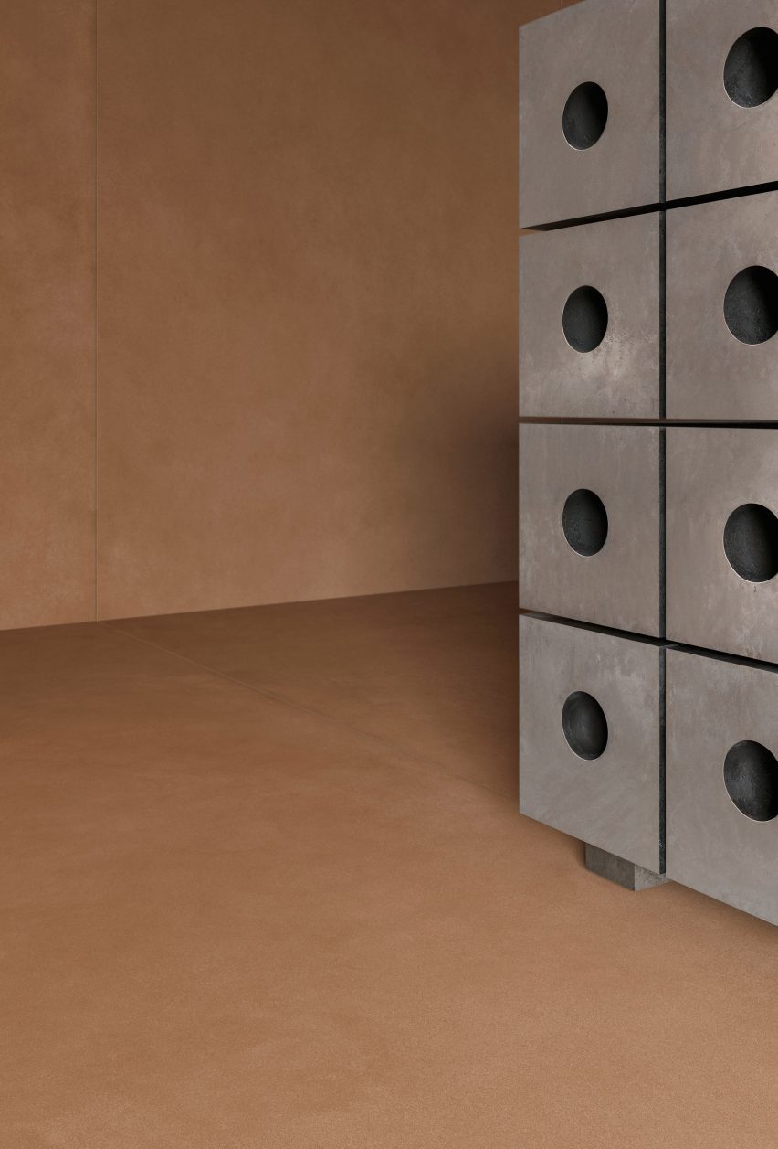 A cropped photograph of a piece of silver furniture against a brown tiled wall and floor