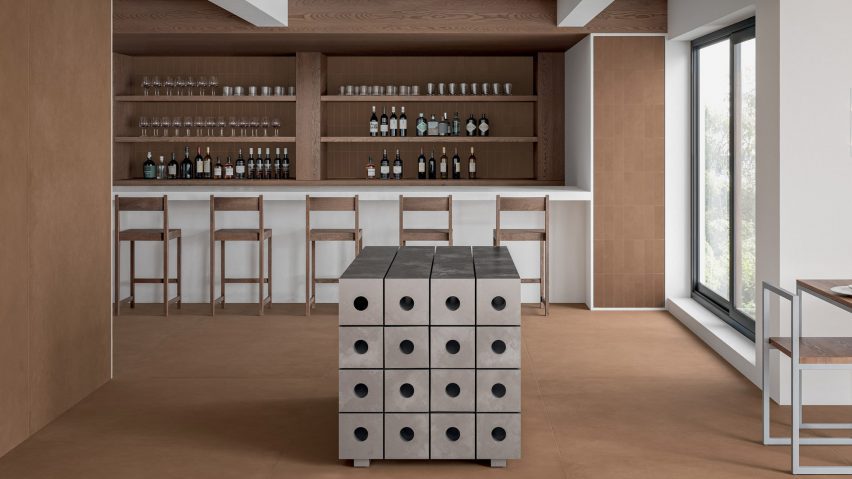 A photograph of a room with white, brown and silver furniture in it and brown tiled walls and floors