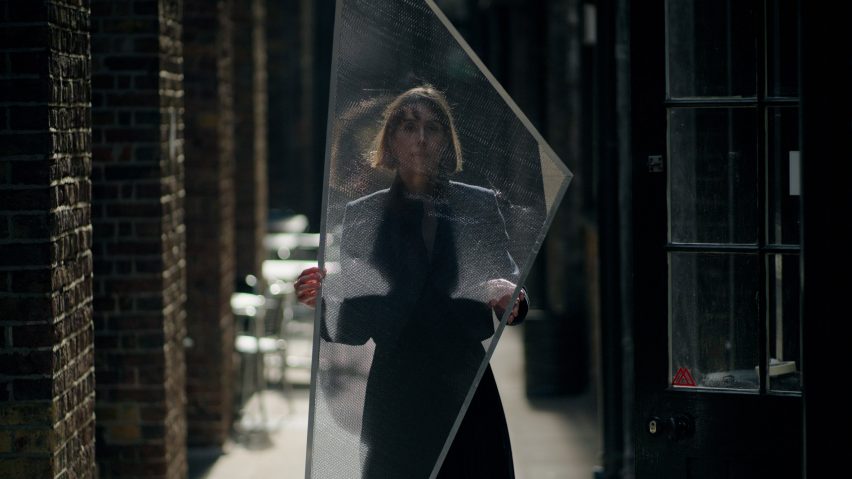 Nassia Inglessis holding one of the honeycomb aluminium wings of her installation