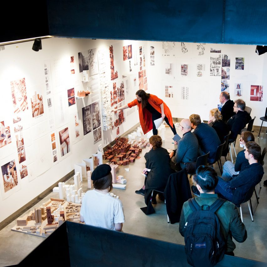 A photograph of a classroom in which students are showcasing architecture work