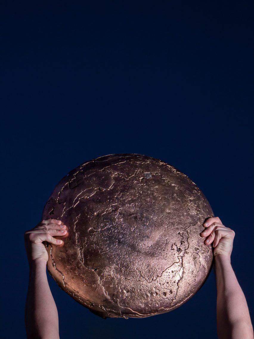 Student holding up a metal object