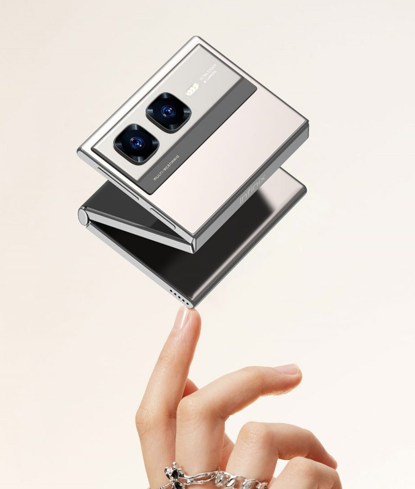 Rendering of the Infinix Zero Series Mini Tri-Fold phone hovering mid-fold over a person's fingertips