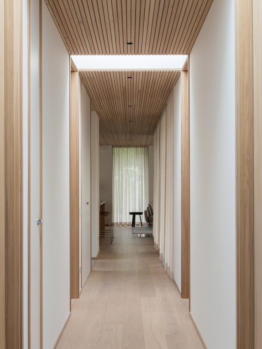Corridor within wooden-clad home by Johan Sundberg Arkitektur