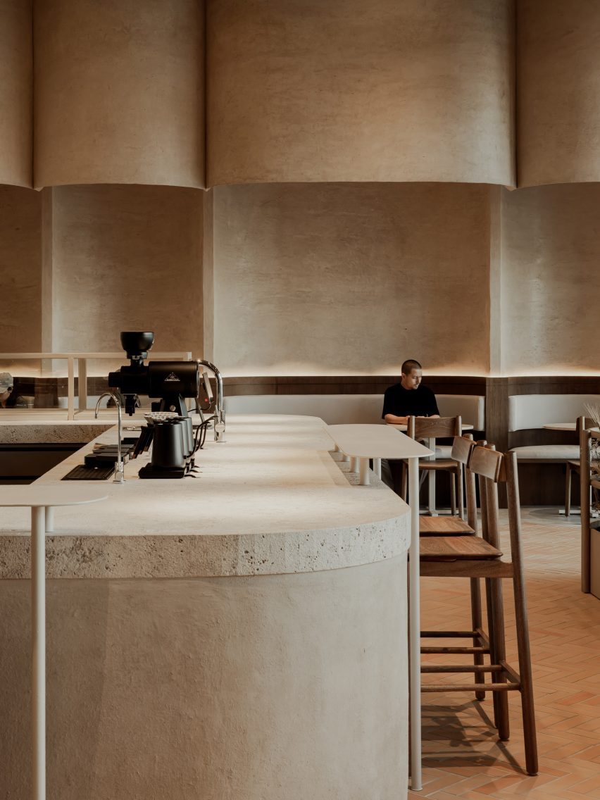 Bakery interior with a central service counter made from compounded earth
