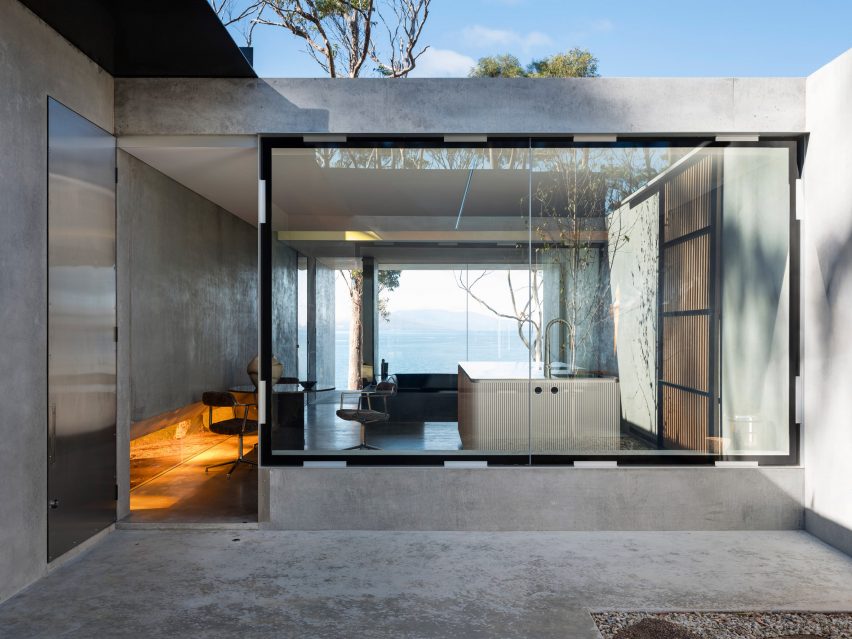 View of courtyard within concrete guesthouse by Room11