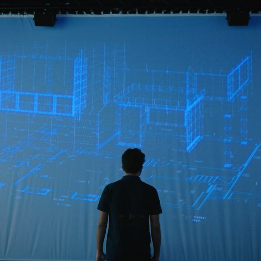 a photograph of a person in front of a projected screen