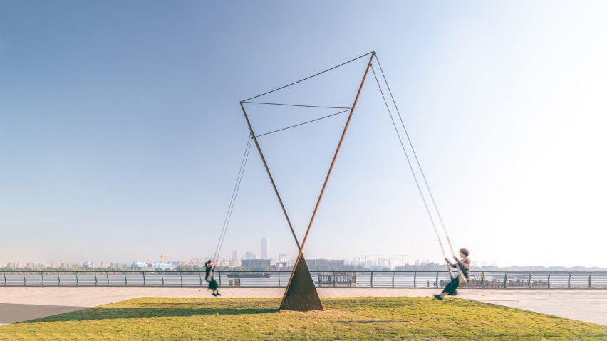 A photograph of a large outdoor installation within a green field.