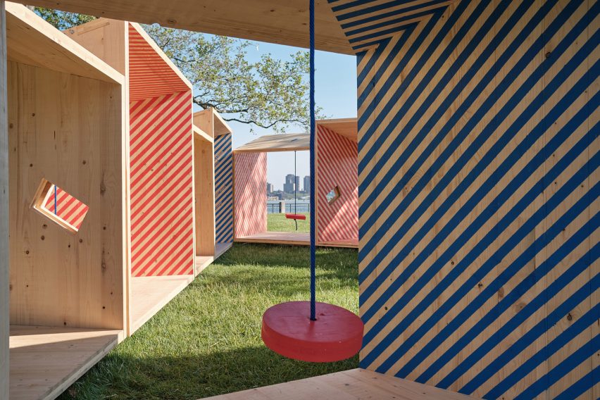 A photograph of a group of wooden structures in red and blue striped patterns.