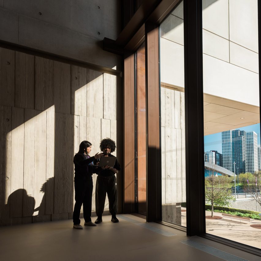 People standing next to a window