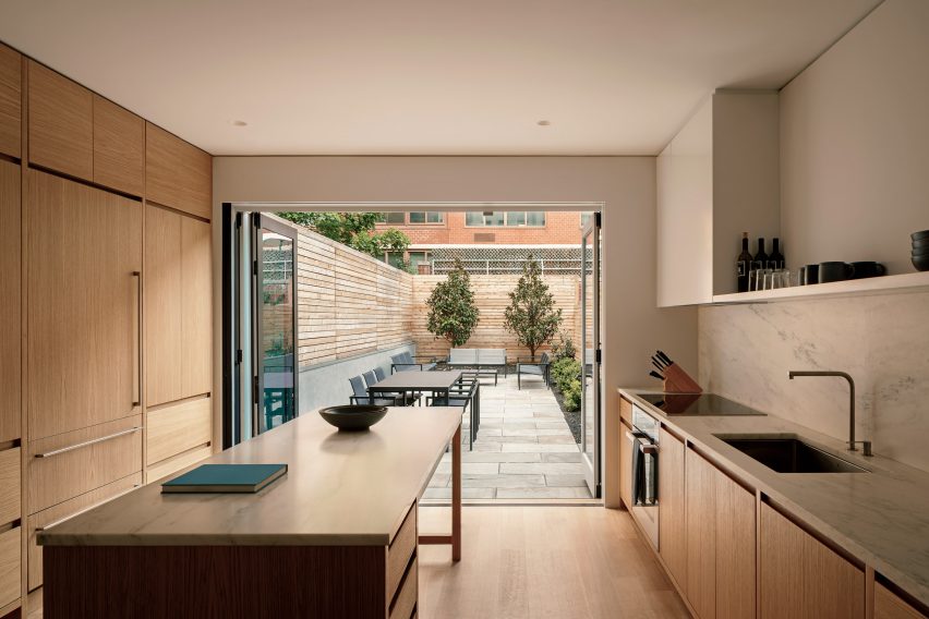 Oak kitchen open to a back patio