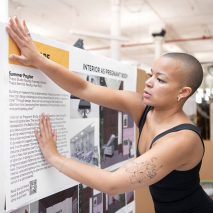 Photo of person putting up a poster