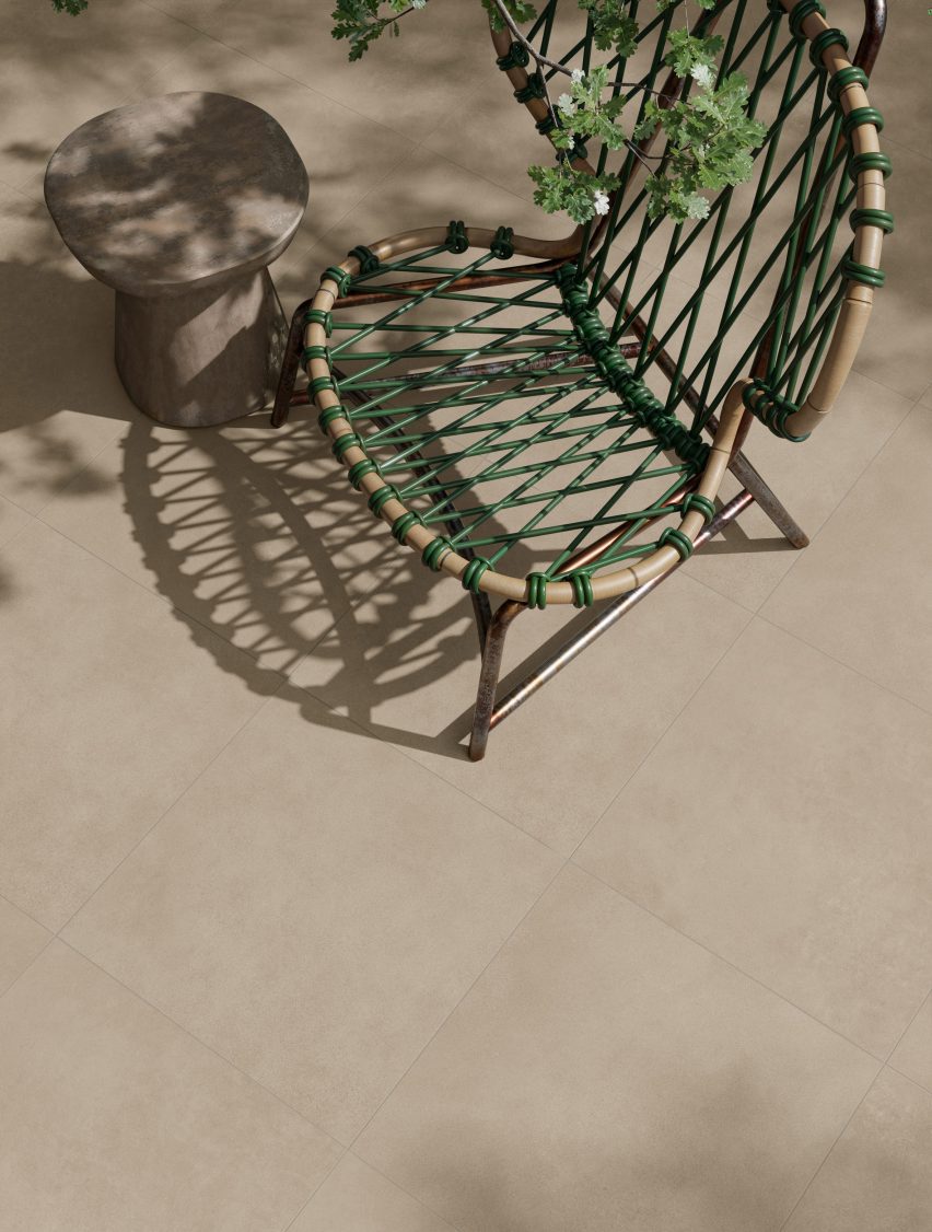 A photograph of a beige- tiled floor with a green crotched garden chair