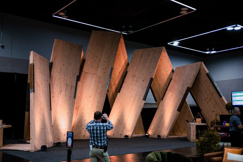 Guy taking a picture of a wooden installation