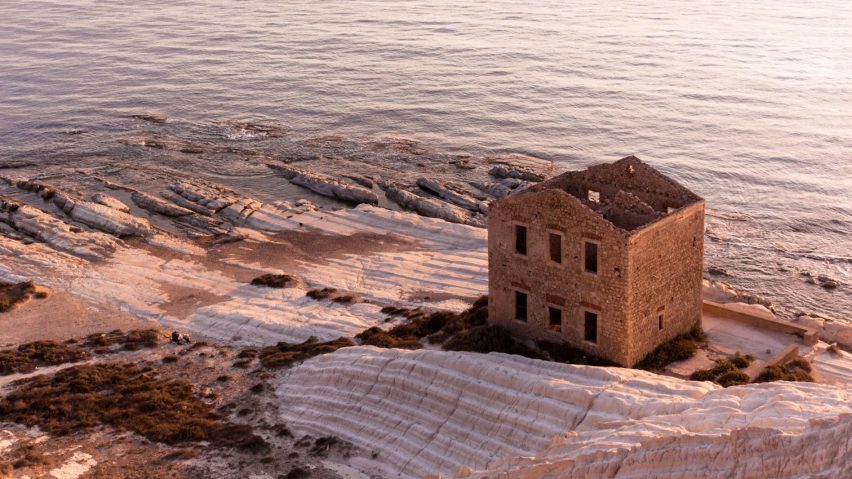 a photograph of a beige stone ruin on the coast