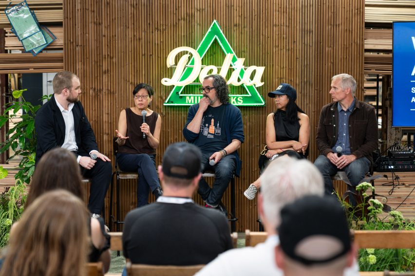 Photo of participants speaking on a panel at Delta Millworks, with Katherine Chia speaking into the microphone