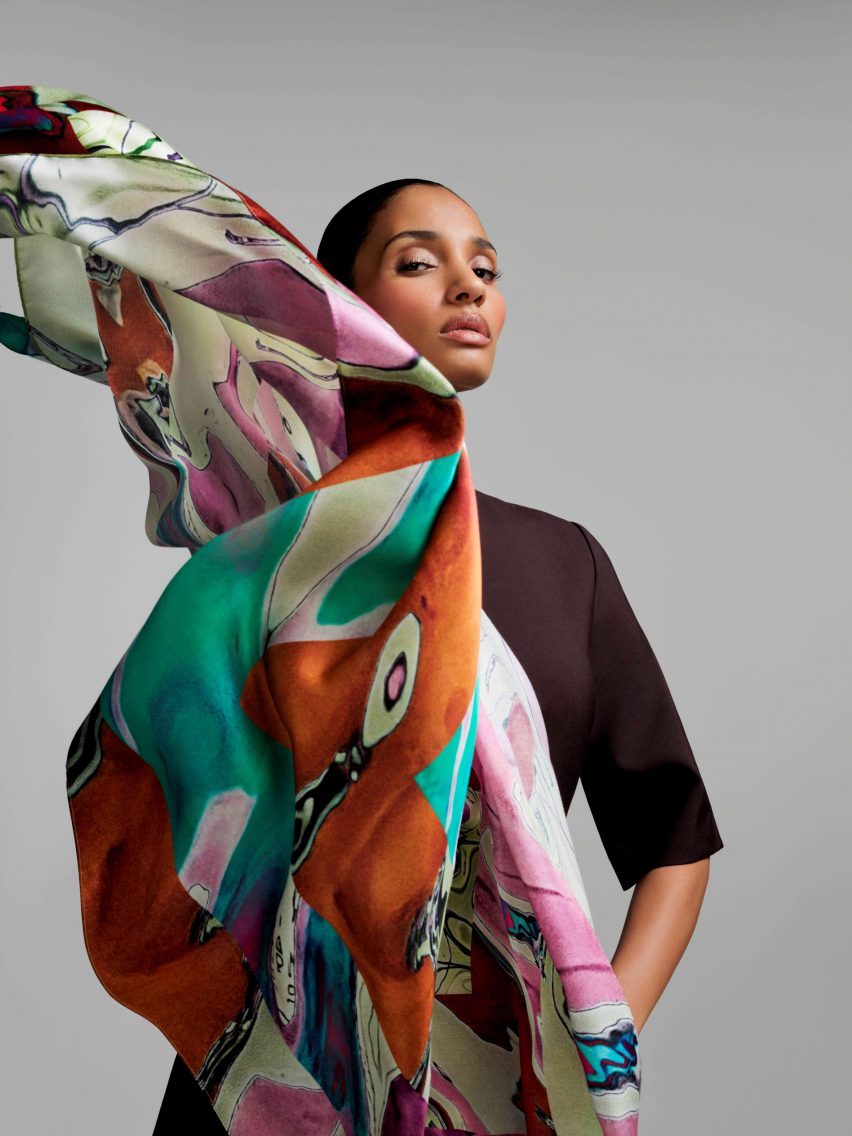 A woman holding a scarf to her face