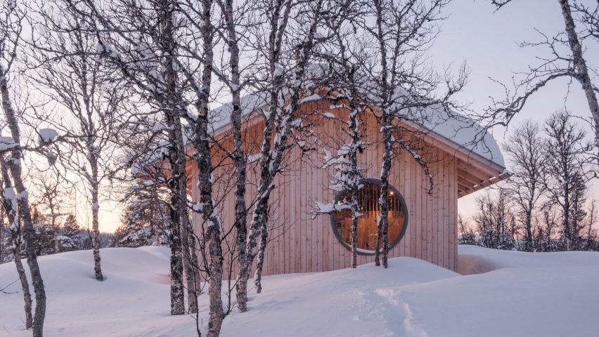 Timber cabin in snowy woodland Norway