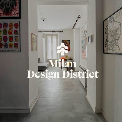 a photograph of an apartment with a grey concrete floor and white walls. Over the photograph is white text which reads 'milan design district'