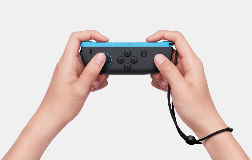 Image of a person's hands holding a Nintendo Switch 2 Joy-Con controller in horizontal mode