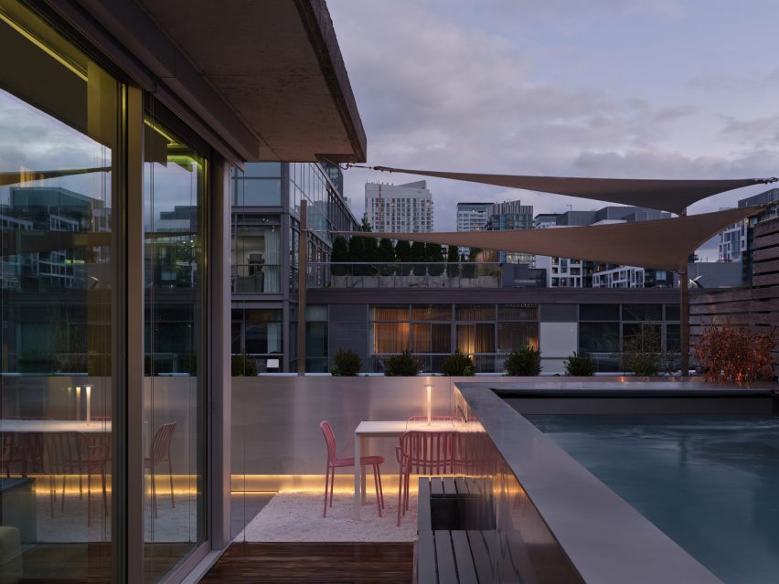 A roof terrace including an outdoor dining area and a raised pool
