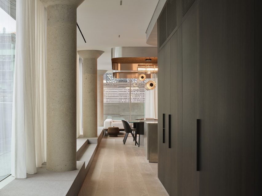 Corridor with dark-stained millwork on one side