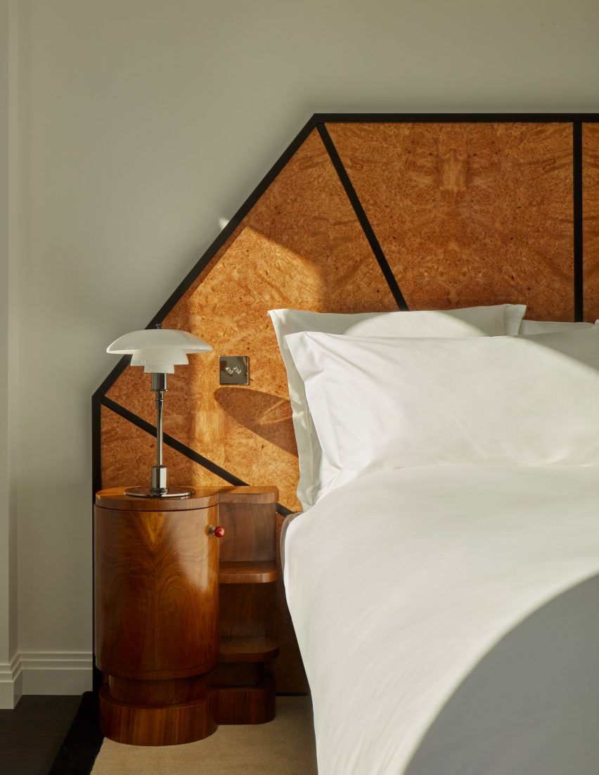 Burl wood headboard and white glass and chrome bedside lamp