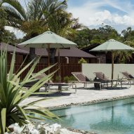 Pool area with loungers and trees