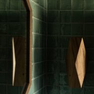 Wooden wall light in tiled bathroom