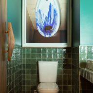 Toilet below photo of urinal