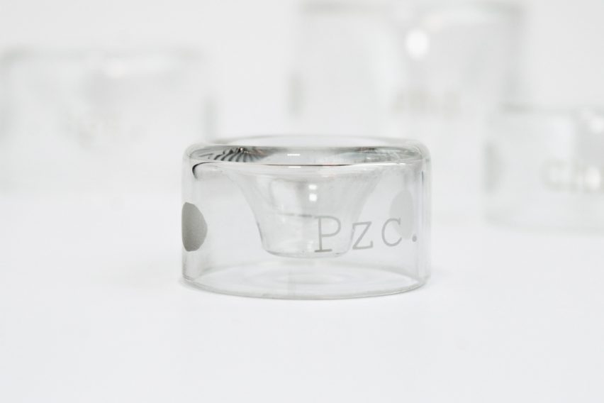 a photograph of a cylindrical object made of translucent material, against a white backdrop